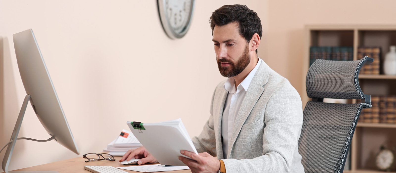 Businessman working with documents at wooden table in office