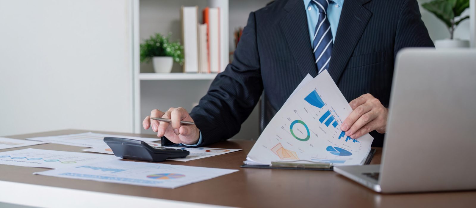 A corporate accountant reviews financial reports, ensuring accuracy and compliance in business strategy.